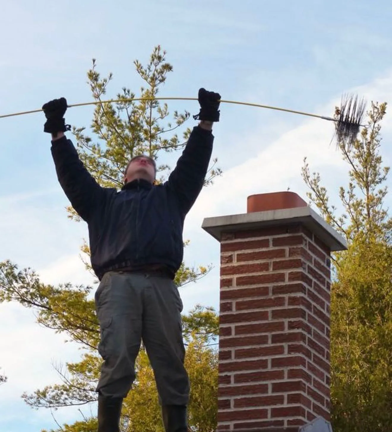 Chimney Cleaning in Hingham, MA — Sweeping the flue from the roof