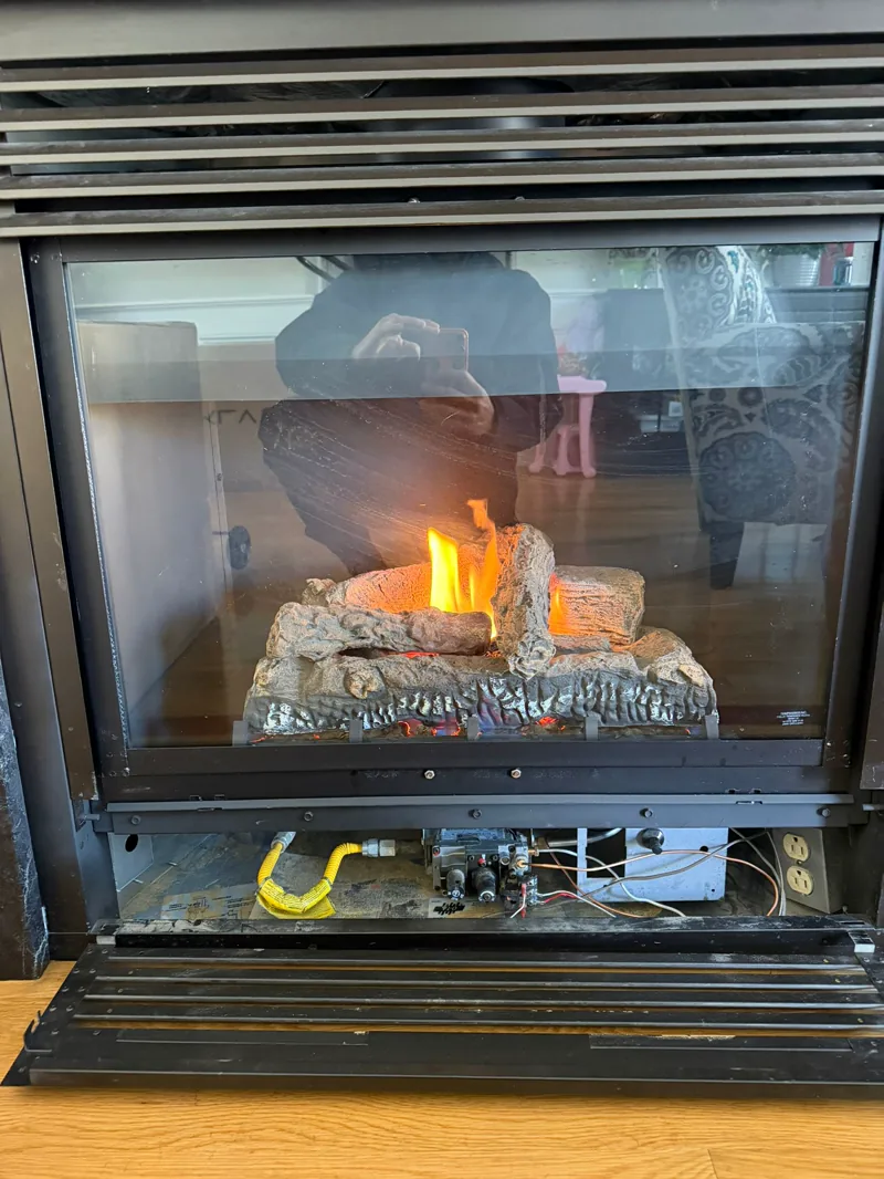Gas fireplace burner and gas line during repair — gas fireplace service example by Chimney Goat