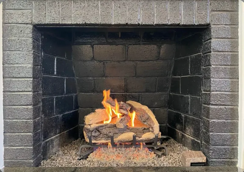 Gas log set burning in a firebox — gas fireplace service example