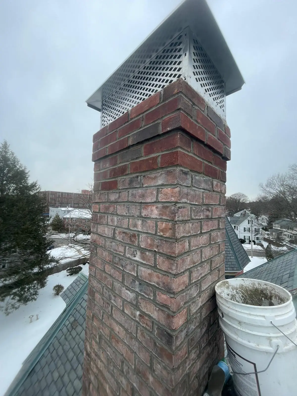 Finished brick chimney with repointed joints and new cap
