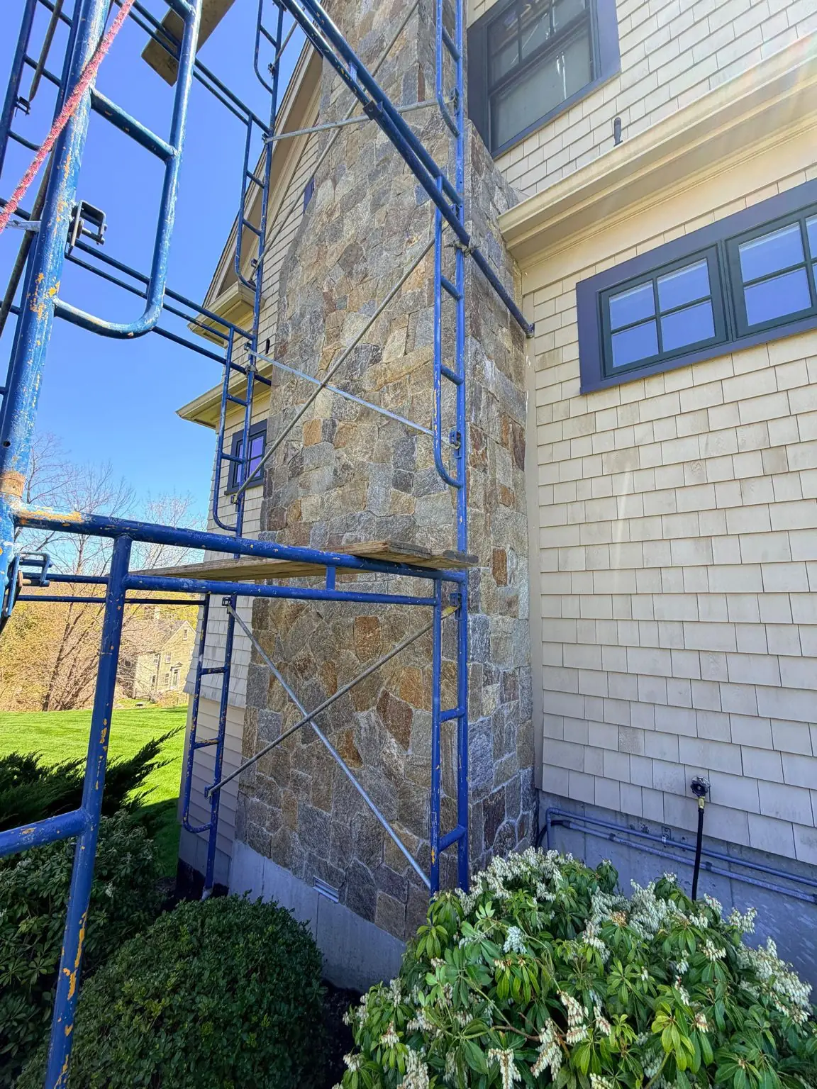 Stone chimney masonry repointing jobsite in Quincy
