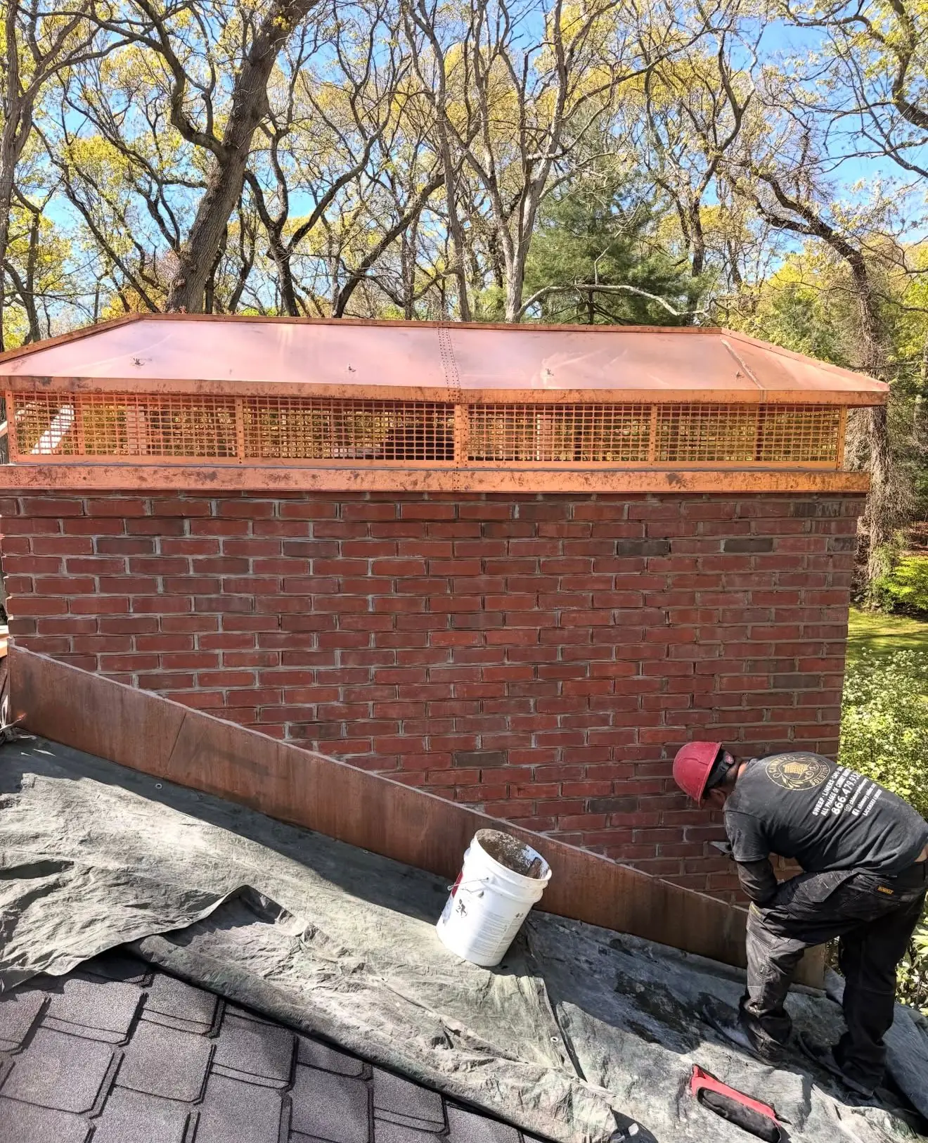 Custom copper chimney cap with new copper flashing on a brick chimney