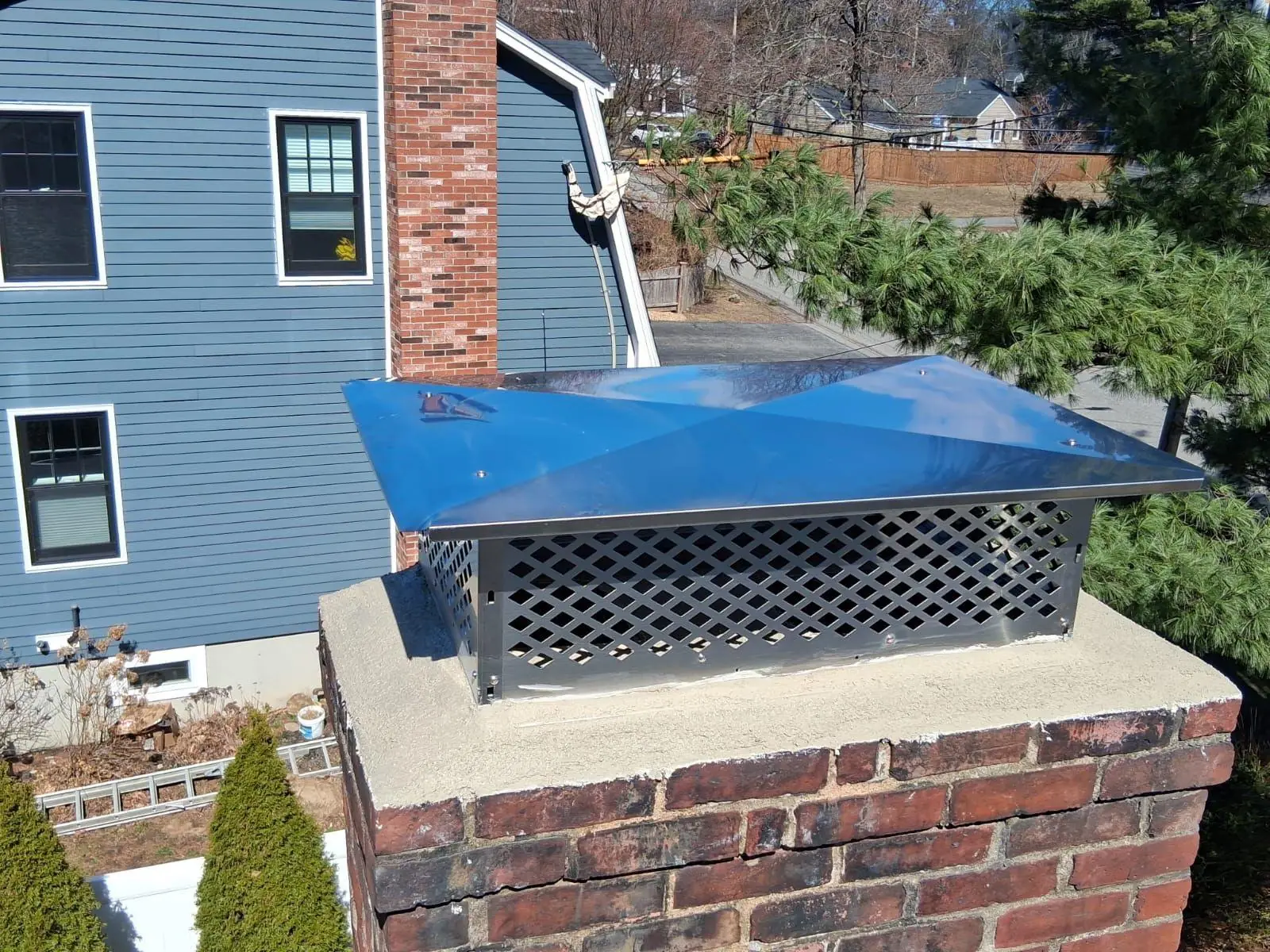 Brick chimney with a new concrete crown and stainless cap
