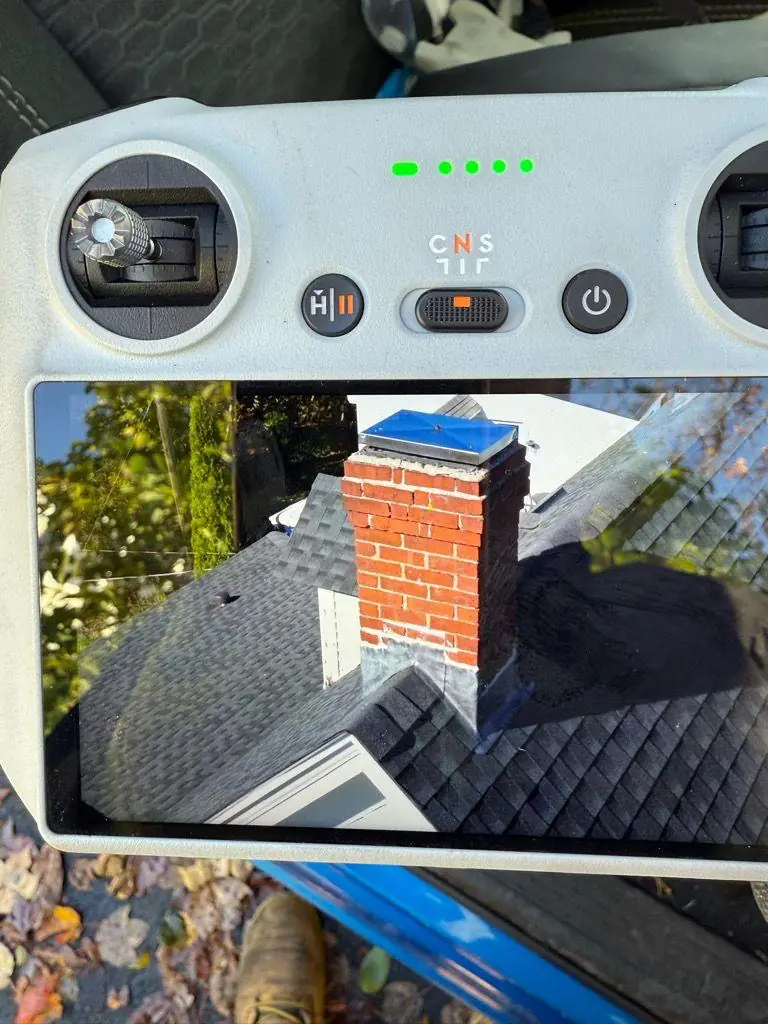 Aerial drone view of a brick chimney with a new cap
