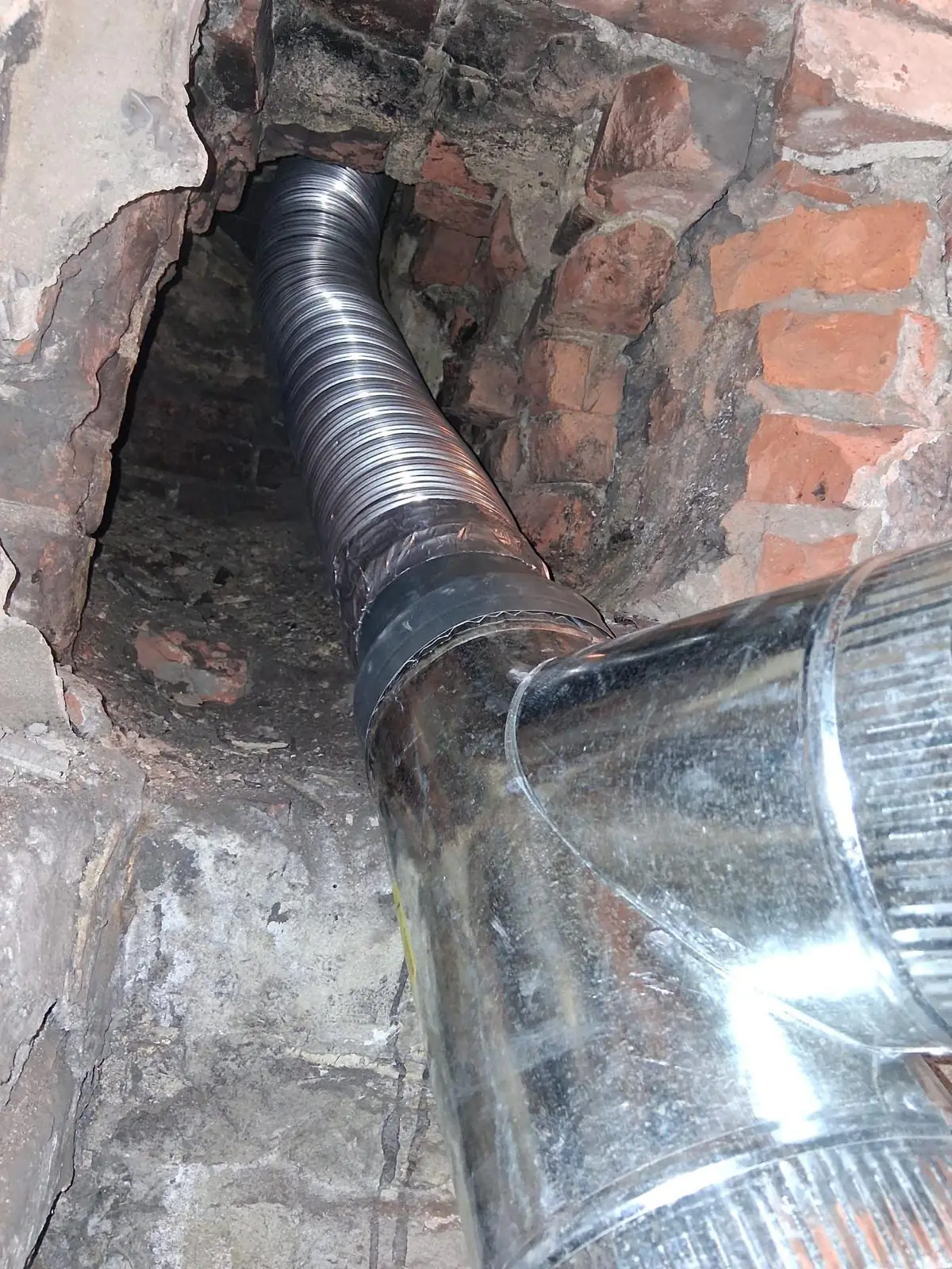 Stainless flex liner inside an interior brick chimney chase