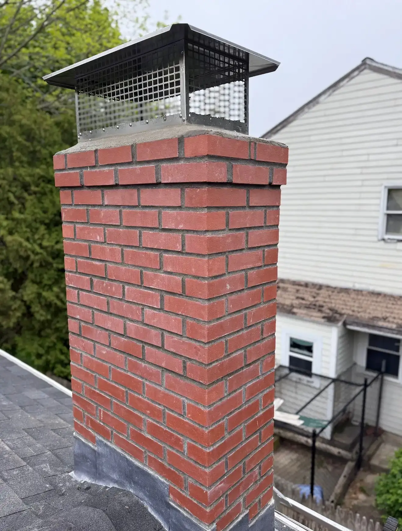 Finished brick chimney rebuild with a new stainless cap