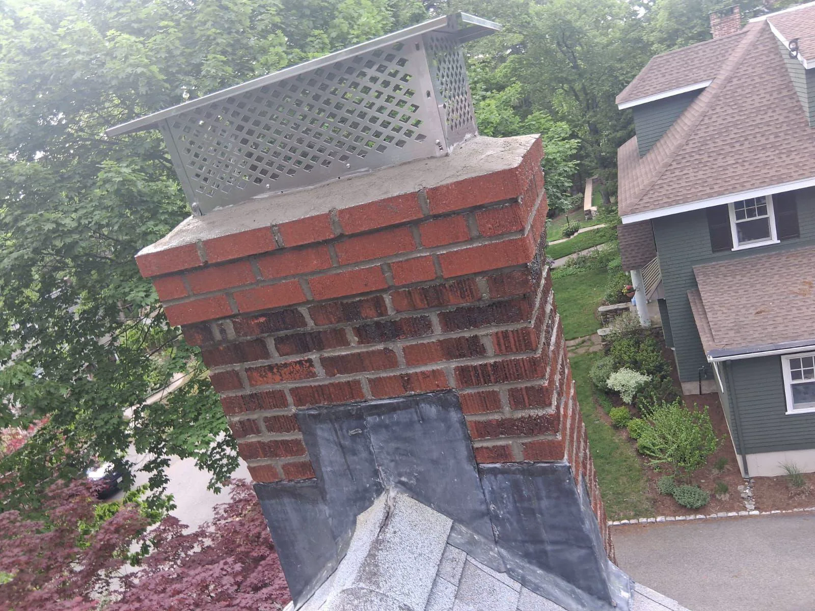 Finished brick chimney repair with a new crown and stainless cap