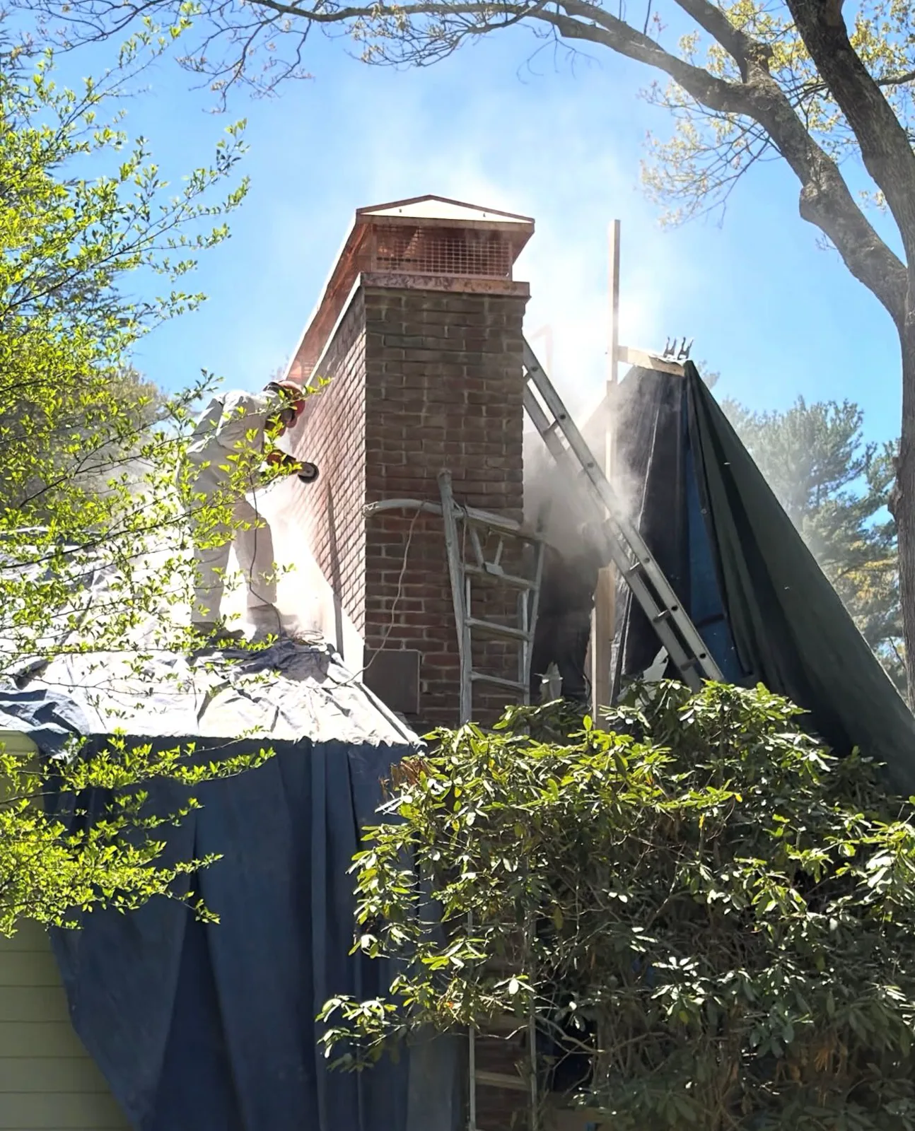 Chimney masonry repair in progress on a South Shore rooftop