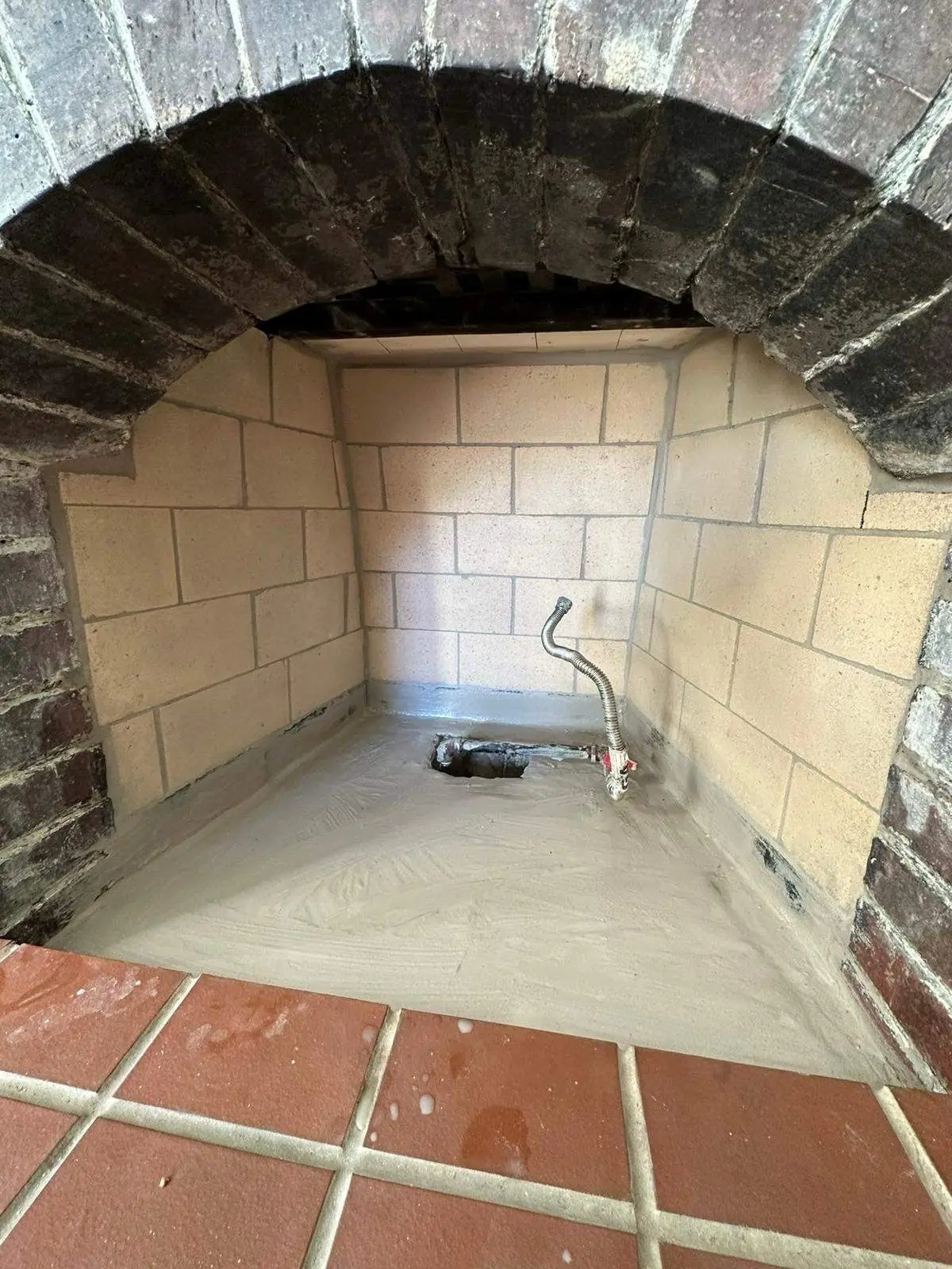 Rebuilt brick firebox with new refractory walls and a gas line stub in Quincy