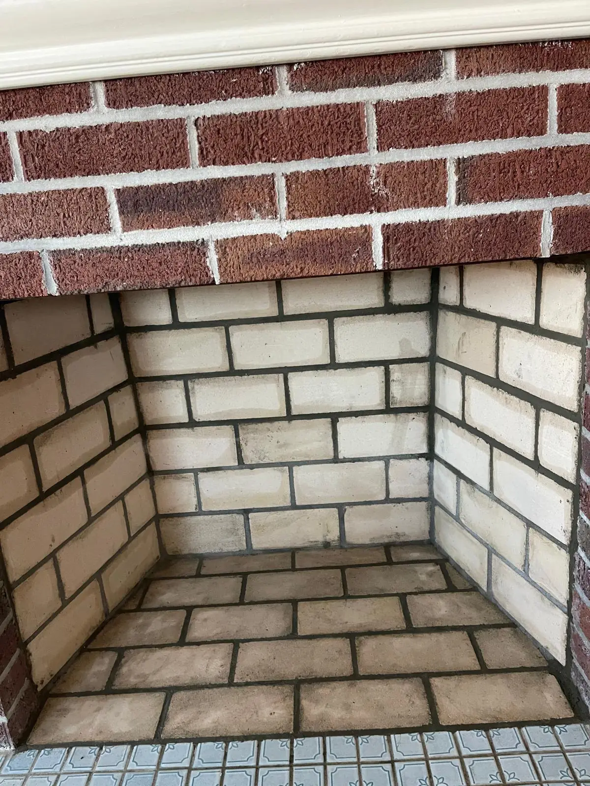 Rebuilt natural stone fireplace firebox interior with a new grate