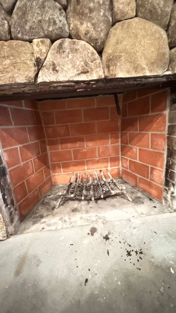Firebox relined with new firebrick inside a stone fireplace