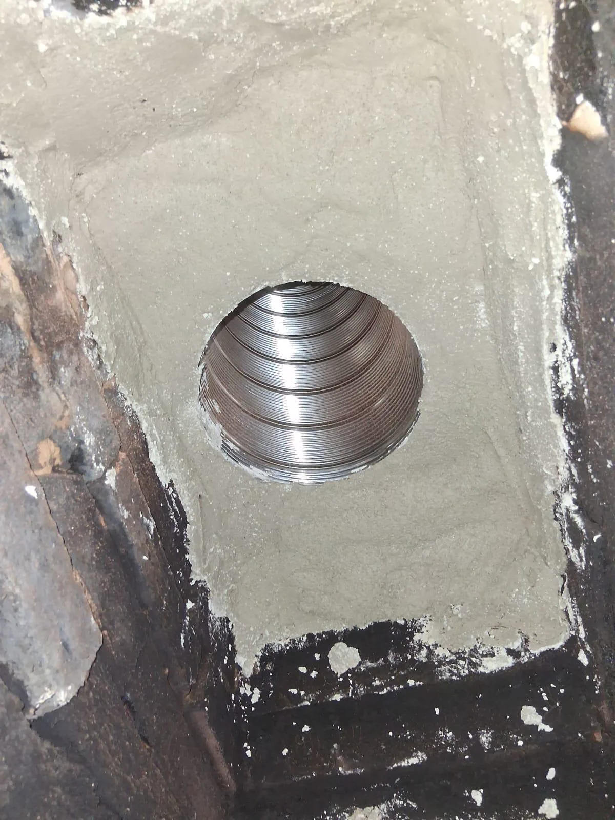 Stainless liner sealed into a freshly parged smoke shelf