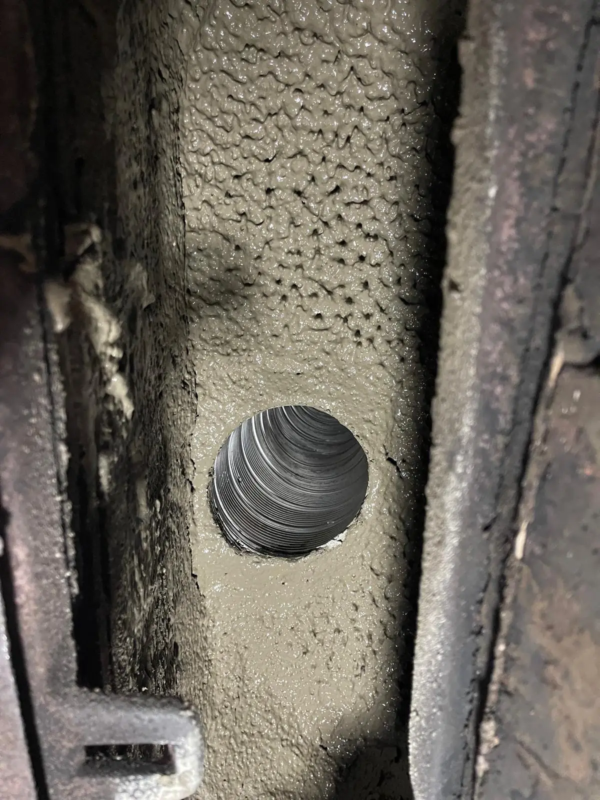 Freshly parged smoke chamber around the flue thimble
